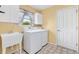 Laundry room with washer, dryer, sink, and cabinets at 9400 Se 176Th Saffold St, The Villages, FL 32162