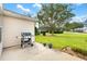 Backyard patio with gas grill and ample green space at 9400 Se 176Th Saffold St, The Villages, FL 32162