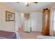 Bedroom view showcasing closet doors, dresser with mirror, and peach carpeting at 1401 W Highway 50 # 12, Clermont, FL 34711