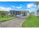 Charming mobile home with well-maintained lawn and covered carport, providing comfortable and convenient living at 1401 W Highway 50 # 12, Clermont, FL 34711