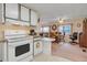 Well-lit kitchen with efficient appliances and breakfast bar adjacent to the living space at 1401 W Highway 50 # 12, Clermont, FL 34711