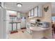 Efficient kitchen featuring white appliances and ample counter space, seamlessly connecting to the living area at 1401 W Highway 50 # 12, Clermont, FL 34711