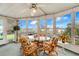 Bright sunroom with wicker furniture, offering views of the surrounding waterfront at 1401 W Highway 50 # 12, Clermont, FL 34711