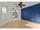 Bedroom with wood flooring, blue accent wall at 1785 Bassinger Ct, The Villages, FL 32162