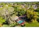 Aerial view showing home, pool, and landscaping; near waterfront at 1785 Maine Ct, Tavares, FL 32778