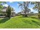 Spacious backyard with lush grass and mature trees at 1785 Maine Ct, Tavares, FL 32778