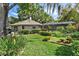 Landscaped backyard with a pool and screened enclosure at 1785 Maine Ct, Tavares, FL 32778
