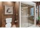 Clean bathroom with toilet and a large glass-enclosed shower at 1785 Maine Ct, Tavares, FL 32778