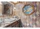 Small bathroom with vanity, stained glass accents and wood cabinets at 1785 Maine Ct, Tavares, FL 32778