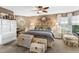 Spacious bedroom with large bed, ample natural light, and decorative accents at 1785 Maine Ct, Tavares, FL 32778
