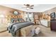 Bright bedroom featuring a king-size bed, decorative pillows, and a TV at 1785 Maine Ct, Tavares, FL 32778