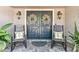 Charming front porch with rocking chairs and elegant double doors at 1785 Maine Ct, Tavares, FL 32778