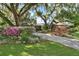 Beautiful home with lush landscaping, long driveway, and mature oak trees at 1785 Maine Ct, Tavares, FL 32778