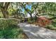 Two-story home with a long driveway and manicured landscaping at 1785 Maine Ct, Tavares, FL 32778