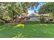 One-story home with lush landscaping and a circular driveway at 1785 Maine Ct, Tavares, FL 32778