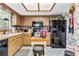 Functional kitchen with wood cabinets and black appliances at 1785 Maine Ct, Tavares, FL 32778