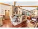 Spacious living area with hardwood floors, stone fireplace, and high ceilings at 1785 Maine Ct, Tavares, FL 32778