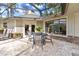 Brick patio with table and chairs, adjacent to the pool at 1785 Maine Ct, Tavares, FL 32778