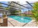 Inviting swimming pool with brick pavers and screened enclosure at 1785 Maine Ct, Tavares, FL 32778