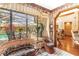 Bright sunroom with wicker furniture overlooking the pool at 1785 Maine Ct, Tavares, FL 32778