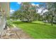 Backyard with grassy area, trees, and a grill at 10301 Us Highway 27 # 178, Clermont, FL 34711