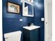 Stylish navy blue bathroom with a white vanity and a small mirror at 10301 Us Highway 27 # 178, Clermont, FL 34711