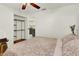 Bedroom with king bed, ceiling fan, and view into kitchen at 10301 Us Highway 27 # 178, Clermont, FL 34711