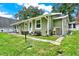 Exterior view of the house, showcasing green siding and landscaping at 10301 Us Highway 27 # 178, Clermont, FL 34711