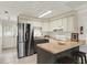 Modern kitchen with stainless steel refrigerator and white cabinets at 10301 Us Highway 27 # 178, Clermont, FL 34711