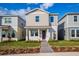 Two-story tan house with a purple door and landscaped lawn at 17036 Clear Mind Aly, Winter Garden, FL 34787