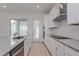 Modern kitchen with white cabinets, stainless steel appliances and an island at 17036 Clear Mind Aly, Winter Garden, FL 34787