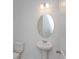 Simple powder room with pedestal sink and oval mirror at 17036 Clear Mind Aly, Winter Garden, FL 34787