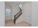 Modern staircase with black metal railings and light wood floors at 17036 Clear Mind Aly, Winter Garden, FL 34787