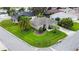 Aerial view of home with a well-manicured lawn, mature landscaping, and a prime corner lot at 1902 Rosario Rd, Lady Lake, FL 32159