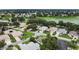 Aerial shot of a residential community, featuring well-maintained lawns, mature trees, and a tranquil lake view at 1902 Rosario Rd, Lady Lake, FL 32159