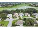 Aerial view of a residential neighborhood with lush green trees, a lake and well-maintained homes at 1902 Rosario Rd, Lady Lake, FL 32159