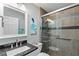 Bathroom featuring granite countertop and shower with glass doors at 1902 Rosario Rd, Lady Lake, FL 32159