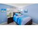 Stylized bedroom featuring colorful decor, bedding, and artwork at 1902 Rosario Rd, Lady Lake, FL 32159