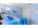 Cozy bedroom features blue walls, nautical themed bedding, and closet at 1902 Rosario Rd, Lady Lake, FL 32159