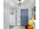 Welcoming home entryway featuring neutral paint, tiled floors, and a charming blue front door at 1902 Rosario Rd, Lady Lake, FL 32159