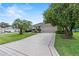 Inviting home exterior with a long driveway, a well-manicured lawn, and a two-car garage at 1902 Rosario Rd, Lady Lake, FL 32159