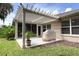 Covered patio with pergola, grill and access to a screened lanai at 1902 Rosario Rd, Lady Lake, FL 32159