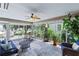 Sunroom filled with plants and comfortable seating, ceiling fan at 1902 Rosario Rd, Lady Lake, FL 32159