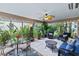 Bright sunroom filled with plants and comfortable seating, ceiling fan at 1902 Rosario Rd, Lady Lake, FL 32159