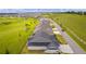 Aerial view of homes with a golf course and lush green landscape in the background at 6867 Mickylee Run, The Villages, FL 34762