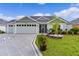 House exterior with gray siding, landscaping, and palm trees at 6867 Mickylee Run, The Villages, FL 34762