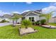 House exterior showcasing landscaping and stone accents at 6867 Mickylee Run, The Villages, FL 34762