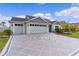 Two story home with gray siding and geometric driveway at 6867 Mickylee Run, The Villages, FL 34762