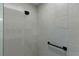 Clean shower with gray tile, black fixtures, and grab bar at 6867 Mickylee Run, The Villages, FL 34762