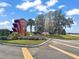 Community entrance sign with well-maintained landscaping and clear signage under a bright, partly cloudy sky at 6419 Borg St, Leesburg, FL 34748